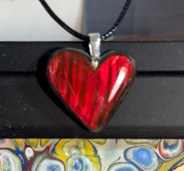 Heart shaped bright red ammolite pendant With a Sterling Silver .925 feather bail