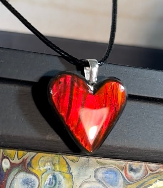 Heart shaped bright red ammolite pendant With a Sterling Silver .925 feather bail