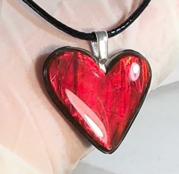 Heart shaped bright red ammolite pendant With a Sterling Silver .925 feather bail